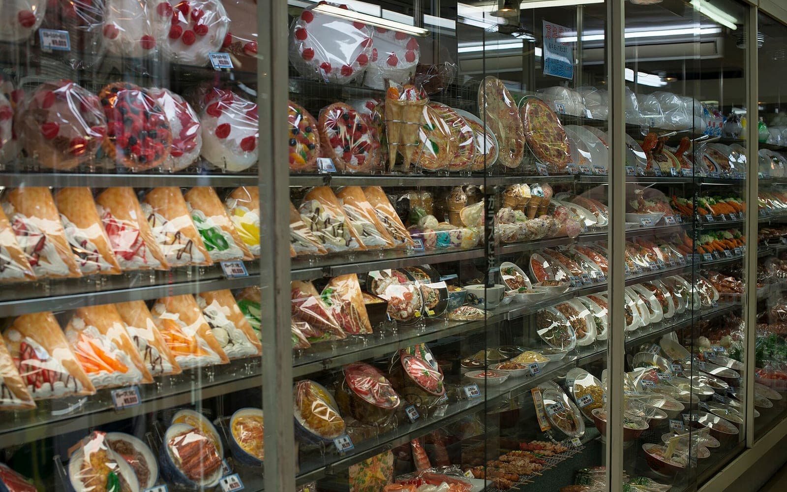 Realistic Japanese plastic food samples displayed in a shop window.