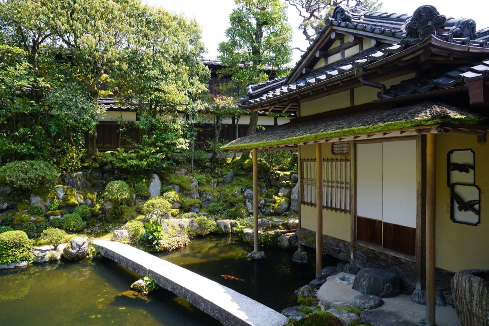 Traditional Japanese interior with shoji screens, tatami flooring, and soft daylight entering the room.